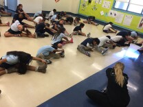 Instructor Bridget McNally leads a second grade class in a warmup before teaching them a combination of dance moves. 