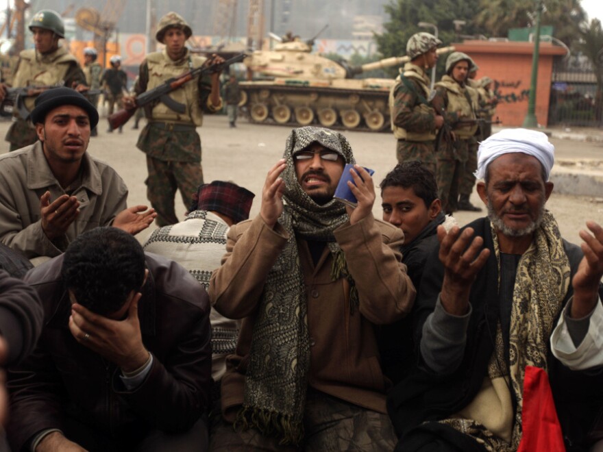 Egyptian anti-government demonstrators and members of the Egyptian Muslim Brotherhood movement pray in Cairo's Tahrir Square on Monday.