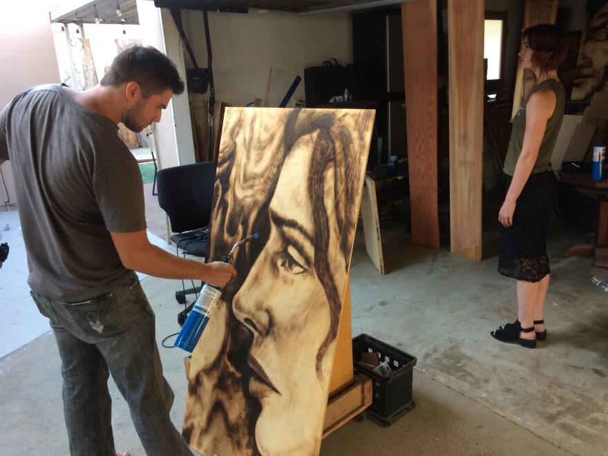 Zachary Aronson works on a portrait of a live model in his studio in Mar Vista.