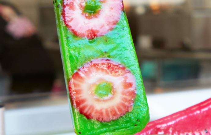Someone holds a popsicle known as a 'paleta' in their hand.