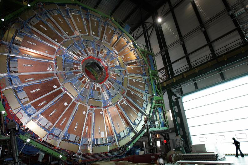 (FILES) This file picture taken on March 22, 2007 shows a woman walking near  the world's largest superconducting solenoid magnet (CMS), at the European Organization for Nuclear Research (CERN)'s Large Hadron Collider (LHC) particule accelerator in Geneva.  In the most complex scientific experiment ever undertaken, the Large Hadron Collider (LHC) will be switched on September 10, 2008 accelerating sub-atomic particles to nearly the speed of light before smashing them together.  AFP PHOTO / FABRICE COFFRINI (Photo credit should read FABRICE COFFRINI/AFP/Getty Images)