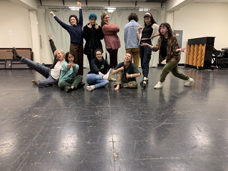 A group of people pose inside a studio.