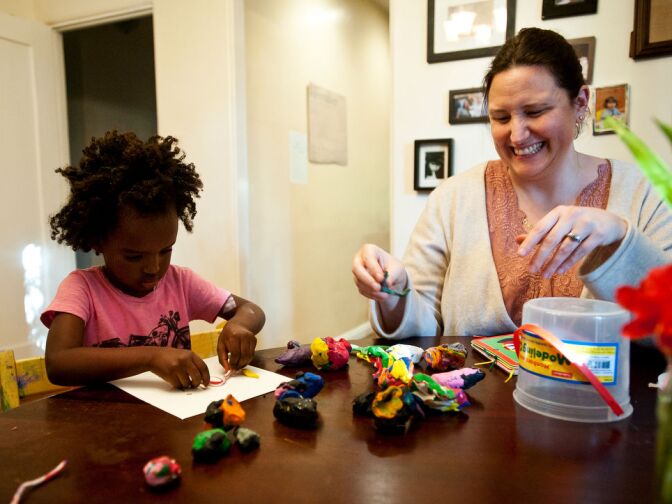 Trista and Luli Schroeder play with modeling clay in their home after school on Monday, Dec. 3.