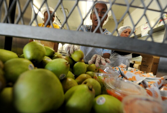 Cafeteria workers prepare lunches for school children at the Normandie Avenue Elementary School in South Central Los Angeles on December 2, 2010.