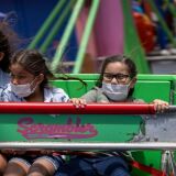 People spins on a ride at Pacific Park amusement park on the Santa Monica Pier as crowds gather on Memorial Day as shutdowns are relaxed more than a year after Covid-19 pandemic shutdowns began, in Santa Monica, California on May 31, 2021. (Photo by DAVID MCNEW / AFP) (Photo by DAVID MCNEW/AFP via Getty Images)