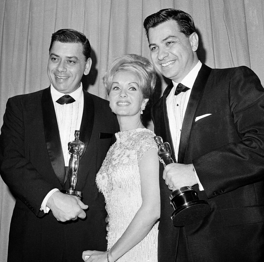 FILE - In this April, 5,1965 file photo actress Debbie Reynolds poses with Academy awards winners for best music Richard M. Sherman, right and Robert Sherman, left, who received the award for Mary Poppins in Santa Monica Calif. Songwriter  Sherman, who wrote the tongue-twisting "Supercalifragilisticexpialidocious" and other enduring songs for Disney classics, has died. He was 86. (AP Photo,File)