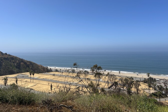 A shot of empty dirt lots of a former mobile home park overlooking the Pacific Ocean in Pacific Palisades on a sunny day. 