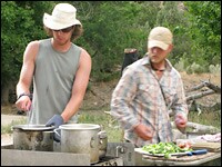 Camp chores like cooking breakfast are shared among the team members.
