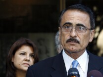 In 2010, Councilman Richard Alarcon, right, and his wife, Flora Montes De Oca Alarcon speak to media outside court where they were indicted on a total of 24 felony counts stemming from allegations Richard Alarcon lived outside his district. The charges were eventually dismissed by a judge, but prosecutors refiled them in the form of a criminal complaint.