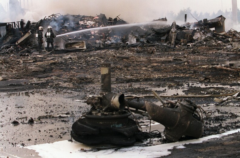 Firefighters spray water amid the debris of Air France Flight 4590. The Concorde crashed shortly after takeoff from Charles de Gaulle Airport on July 25, 2000.