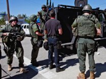 Los Angeles County Sheriff's department officers arrive at a standoff in the Sylmar section of Los Angeles on Monday, April 4, 2011.