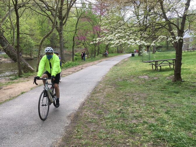 A biker wearing a mask cycles through Rock Creek Park in Washington, D.C. on Saturday, April 15.