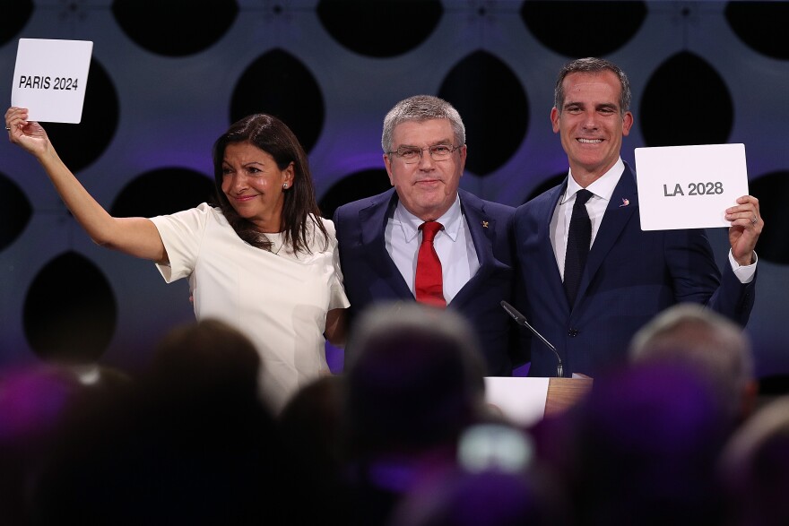 LIMA, PERU - SEPTEMBER 13:  Paris Mayor Anne Hidalgo, IOC President Thomas Bach and Los Angeles Mayor Eric Garcetti react after the confirmation of the tripartite agreement which awards Paris and LA with the Olympic Games of  2024 and 2028 during the 131th IOC Session - 2024 & 2028 Olympics Hosts Announcement at Lima Convention Centre on September 13, 2017 in Lima, Peru.  (Photo by Buda Mendes/Getty Images)