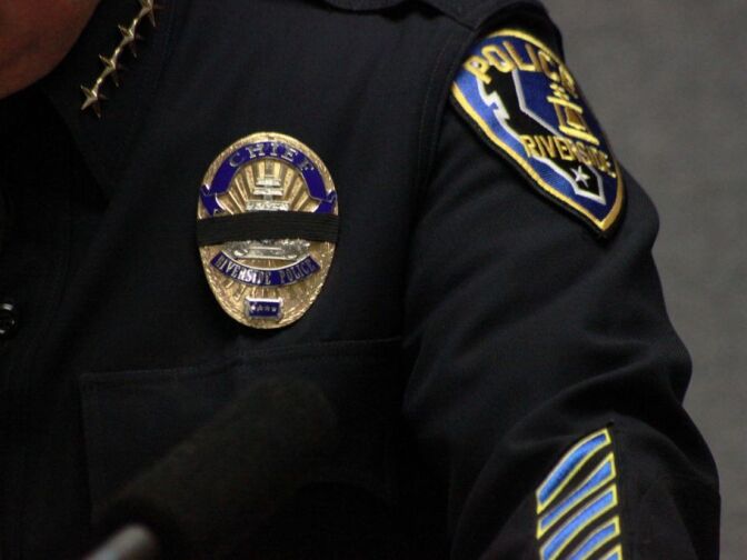 Riverside police officers wear black bands over their badges in honor of RPD officer allegedly gunned down by x-LAPD cop Christopher Dorner. 