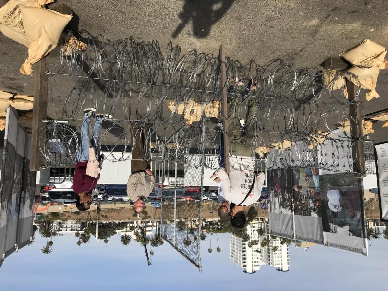 The barbed wire barricades are meant to represent what refugees have to deal with as they flee their home countries.