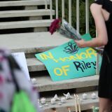 Students lay candles and flowers at the steps of Kennedy Hall to honor the victims of a shooting the day earlier at the University of North Carolina Charlotte, in Charlotte, North Carolina on May 1, 2019. - A 21-year-old student gave his life to save others by tackling a gunman who was shooting up a university classroom, police in the US said May 1, 2019.  Charlotte-Mecklenburg Police Chief Kerr Putney said the authorities were still trying to find a motive for Tuesday's attack at the University of North Carolina, which left undergraduate Riley Howell and another student dead. (Photo by Logan Cyrus / AFP)        (Photo credit should read LOGAN CYRUS/AFP/Getty Images)