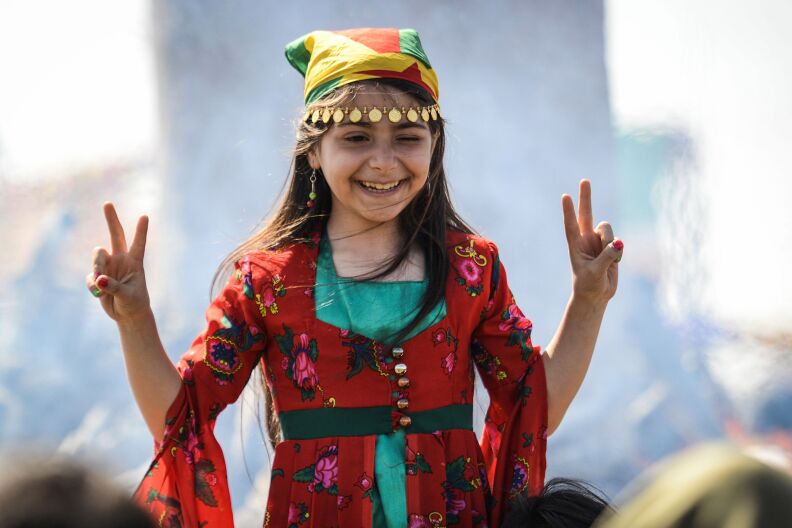 A girl flashes the victory sign as Turkish Kurds gather during Newroz celebrations in Diyarbakir, southeastern Turkey, on March 21, 2018. Also known as Nawroz or Nowruz, it is an ancient Persian festival, which is also celebrated by Kurdish people, marking the first day of spring.