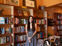 Woman standing in front of bookshelves