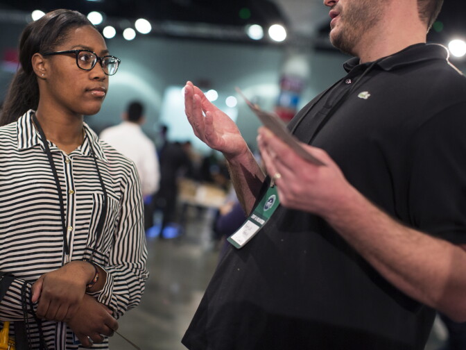 Ariel Flowers, 20, speaks with a Chipotle representative at the Los Angeles Convention Center on Thursday morning, Feb. 11, 2016 during the Los Angeles Opportunity Hiring Fair. Flowers, who was recently laid off, received two job offers on Thursday. 
