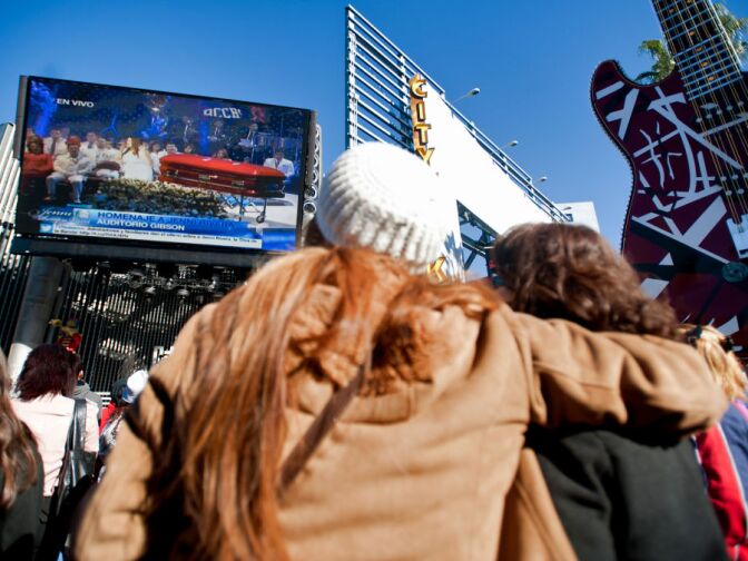 Singer Jenni Rivera's red coffin, decorated with butterflies, is displayed on-stage during her memorial.
