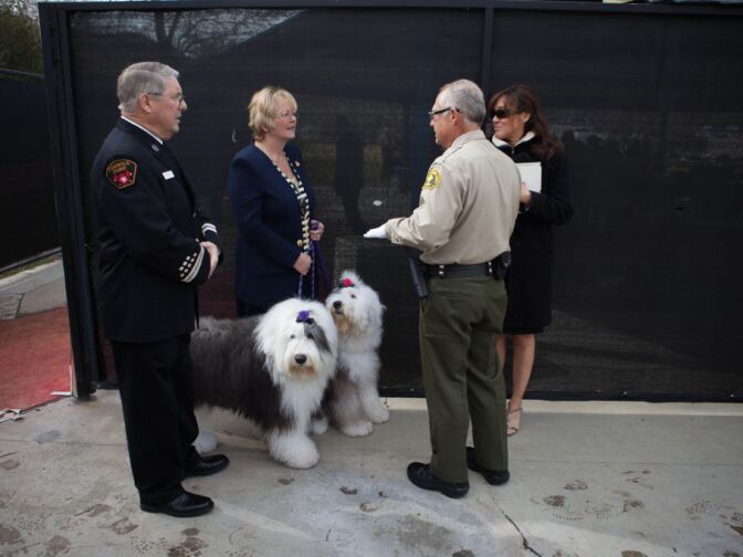 The owners of old english sheepdogs discuss their participation in a funeral for Det. Jeremiah MacKay in San Bernardino on Feb. 21, 2013.