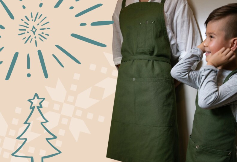 An adult and a child where heavy-duty moss green aprons.