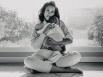 Anna Malaika Tubbs, author of The Three Mothers, holds her infant son, Michael Malakai Tubbs, Jr., in her home.