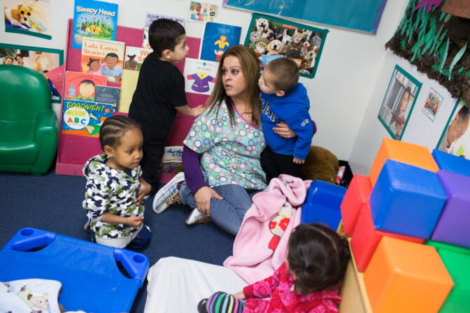 A teacher at Jardín de Niños plays with kids at the school in Lincoln Heights, which receives funding from the California Department of Education. Childcare workers are among the lowest paid professionals in 2014 according to new data from the Economic Policy Institute.
