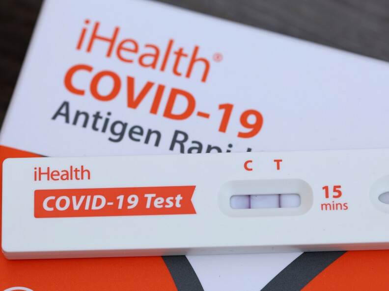 An at-home COVID test shows a positive result.