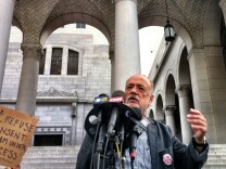 James Lafferty of the National Lawyers Guild announces legal efforts being made to keep the protesters in the park around City Hall on Monday morning.