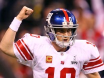 Eli Manning #10 of the New York Giants reacts in the first half while taking on the New England Patriots during Super Bowl XLVI at Lucas Oil Stadium on February 5, 2012 in Indianapolis, Indiana. Manning, named MVP, led the Giants to a 21-17 victory.  