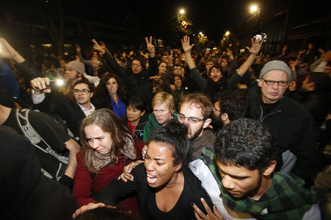 BERKELEY, CA - DECEMBER 7: Demonstrators react as they were being push by by the police on Telegraph Ave during a demonstration over recent grand jury decisions in police-involved deaths on December 7, 2014 in Berkeley, California. A Staten Island, New York grand jury declined on Wednesday to indict New York City Police Officer Daniel Pantaleo in the chokehold death of Eric Garner. (Photo by Stephen Lam/Getty Images)