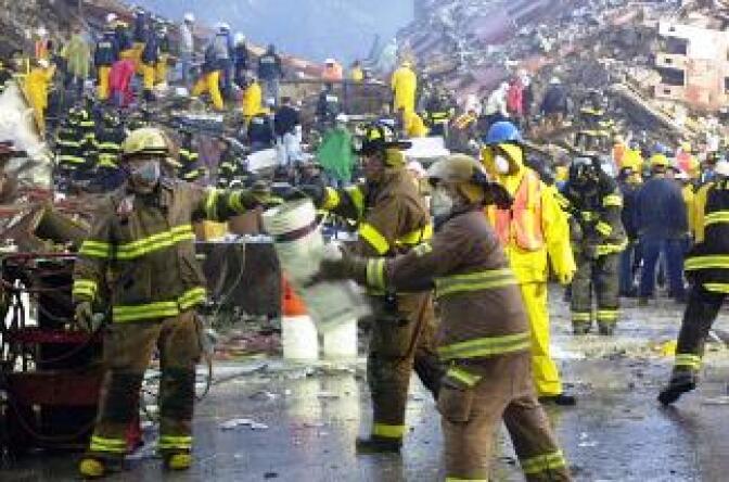 Rescuers at the base of the World Trade Center 14 September 2001, in New York. 
