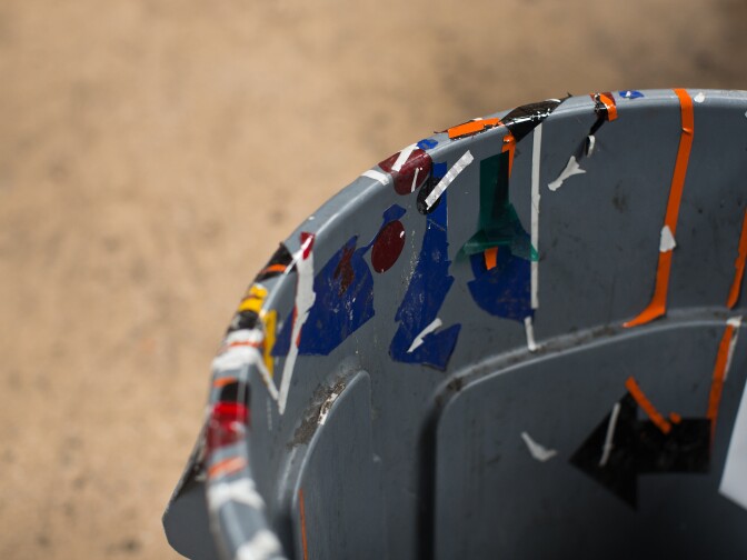 Once designs are approved, they are printed onto large stickers. Sign makers "weed out" the designs using an X-Acto knife.