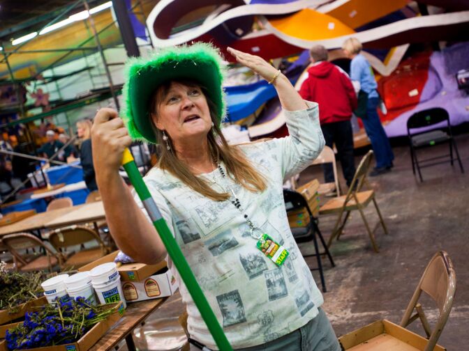 Crystal Ogden of Prescott, Ariz., a crew chief for Phoenix Decorating Company, wears a bright green hat to match the green tractor float she is overseeing.
