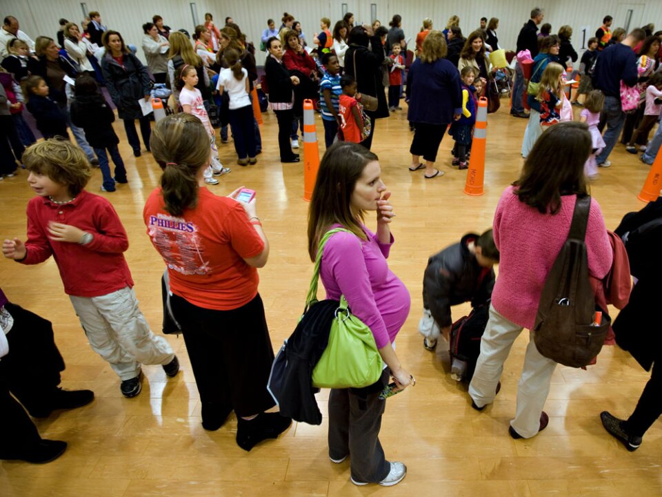 Nicole Andreacchio, who is seven months pregnant, waits in line to receive the swine flu vaccine from the health department Thursday in  Maple Glen, Pa.