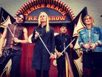 Famous sword-swallower Morgue (center) stands with other sword-swallowers in front of the Venice Beach Freakshow.