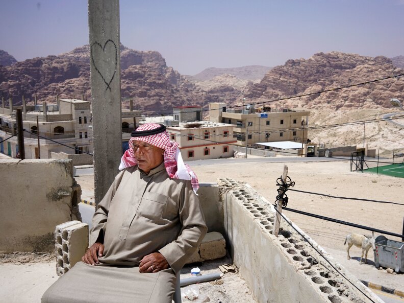 Bedouin village elder Ali Mutlaq Salem sits on his roof in the village of Um Sayhoun, on the outskirts of Petra. Salem was born and raised in one of the caves in Petra.