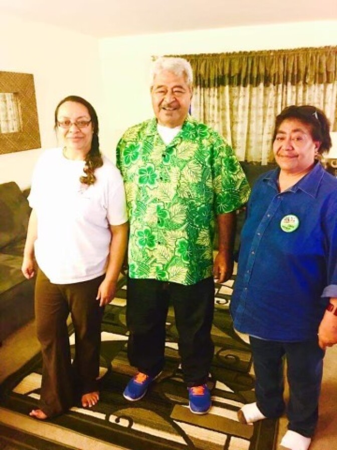Three middle-aged Tongan Americans pose in a house. 