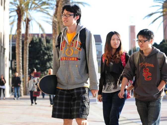 USC students on their way to attend a memorial service on April 18, 2012 in Los Angeles, California, for the two Chinese graduate students who were shot to death near campus last week. US authorities have offered $200,000 in reward money to find whoever killed the two students, after more funds were pledged on April 17.  Los Angeles has a large Chinese and Chinese-American population, including many overseas students and certain areas of the city are known for frequent gun violence. AFP PHOTO/Frederic J. BROWN (Photo credit should read FREDERIC J. BROWN/AFP/Getty Images)
