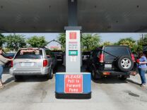 The Labor Department Friday reported that a  rise in food and gas costs drove a measure of U.S. wholesale prices up sharply in May. But outside those volatile categories, inflation was mild. (Photo: Customers gas up their car at a Costco store in Burbank).