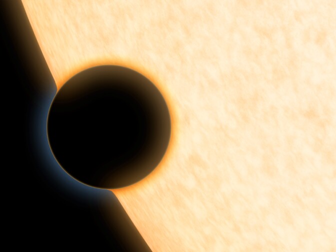 A Neptune-size planet with a clear atmosphere is shown crossing in front of its star in this artist's depiction.