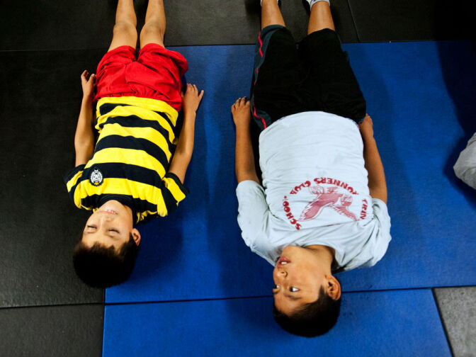 Chriztec Bazaldua, 8, and Carlos Orea, 10, rest in between sit-ups. The activity programs are open to kids between 8 and 18 years old.