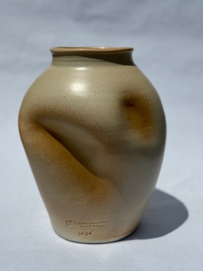 A large brown pot with indentations.