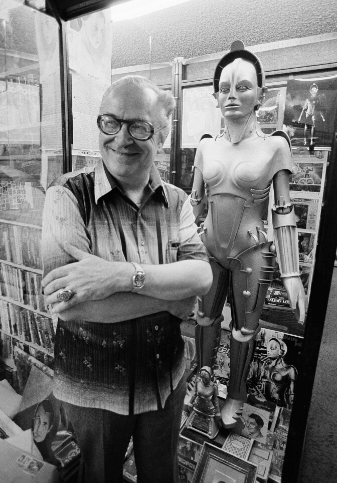 "Mr. Science Fiction", Forrest Ackerman, stands with the reproduction of the female robot Ultima Future Automation from the 1926 German film "Metropolis" in his home in Los Angeles, on Oct. 31, 1979. The robot is surrounded by Ackerman's extensive collection of science fiction and fantasy memorabilia. 