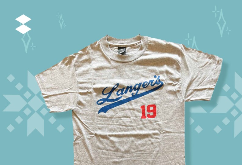 An off-white t-shirt with blue cursive lettering with number nineteen in red lettering just below