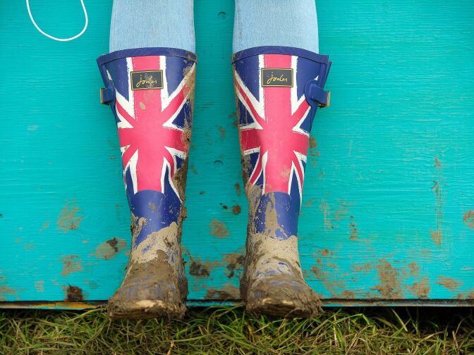 A reveller wears Union Flag Wellington boots on the second day of the Glastonbury Festival of Music and Performing Arts on Worthy Farm near the village of Pilton in Somerset, South West England on June 22, 2016. 