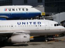 Two United Airlines planes parked at the terminal at San Francisco International Airport in San Francisco. U.S. orders for long-lasting goods that signal business investment plans fell in February 2013 by the largest amount in seven months, although the decline followed a strong month in January and may prove to be a temporary setback. The Commerce Department said Tuesday that orders for so-called core capital goods declined 2.7 percent in February from January.
	
