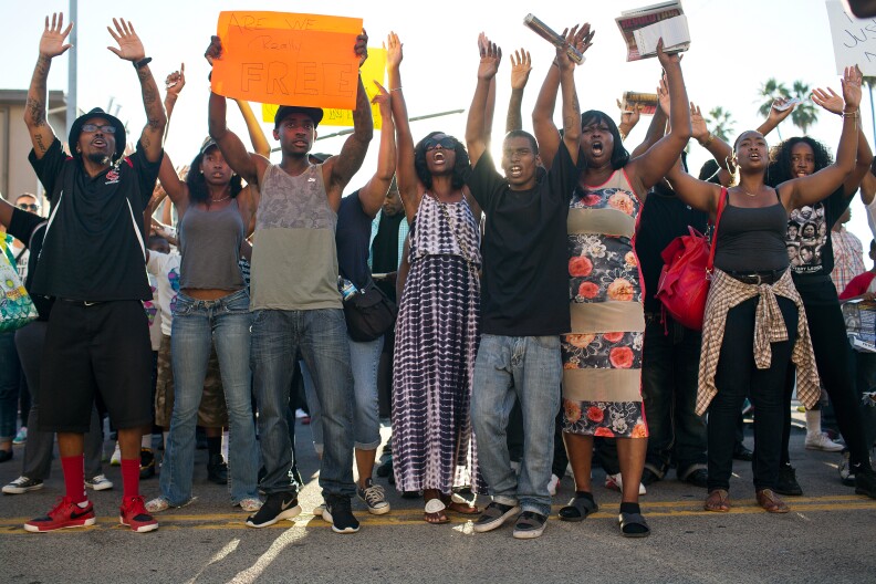 Local residents take part in a march on Thursday evening, Aug. 14 for 25-year-old Ezell Ford who was fatally shot by Los Angeles police on Monday. The march began at West 65th Street where Ford was shot and travelled down South Broadway to LAPD's 77th Division.