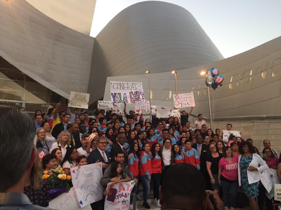 YOLA students and families pose for a group photo on the steps of Disney Hall. LA Philharmonic music director Gustavo Dudamel is in the center of the front row.